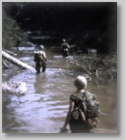 [Troops slog through a Vietnam
jungle]