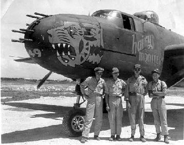 [Smiling guys by WWII
bomber]